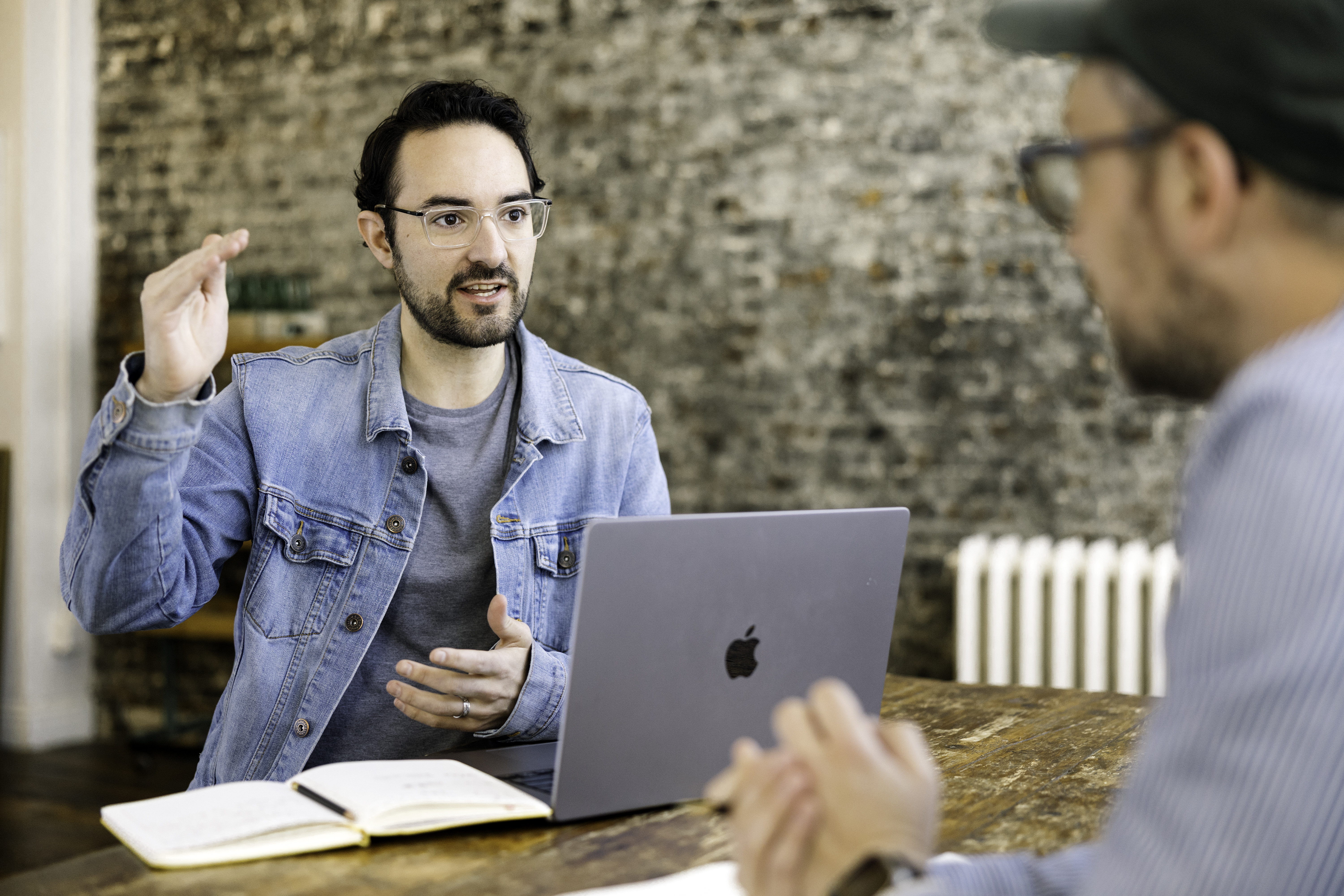 Ben from Contractor Appointments working on computer while talking with someone